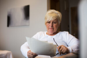 Vrouw van middelbare leeftijd leest brief.